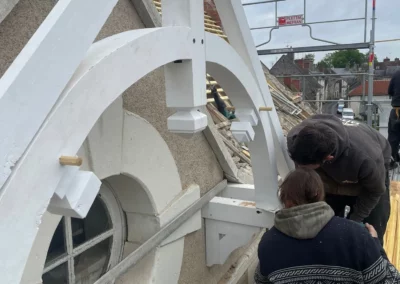 Charpentiers restaurant une lucarne sur toiture échafaudée