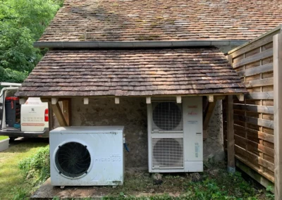 Unités extérieures de pompe à chaleur sous toiture ancienne